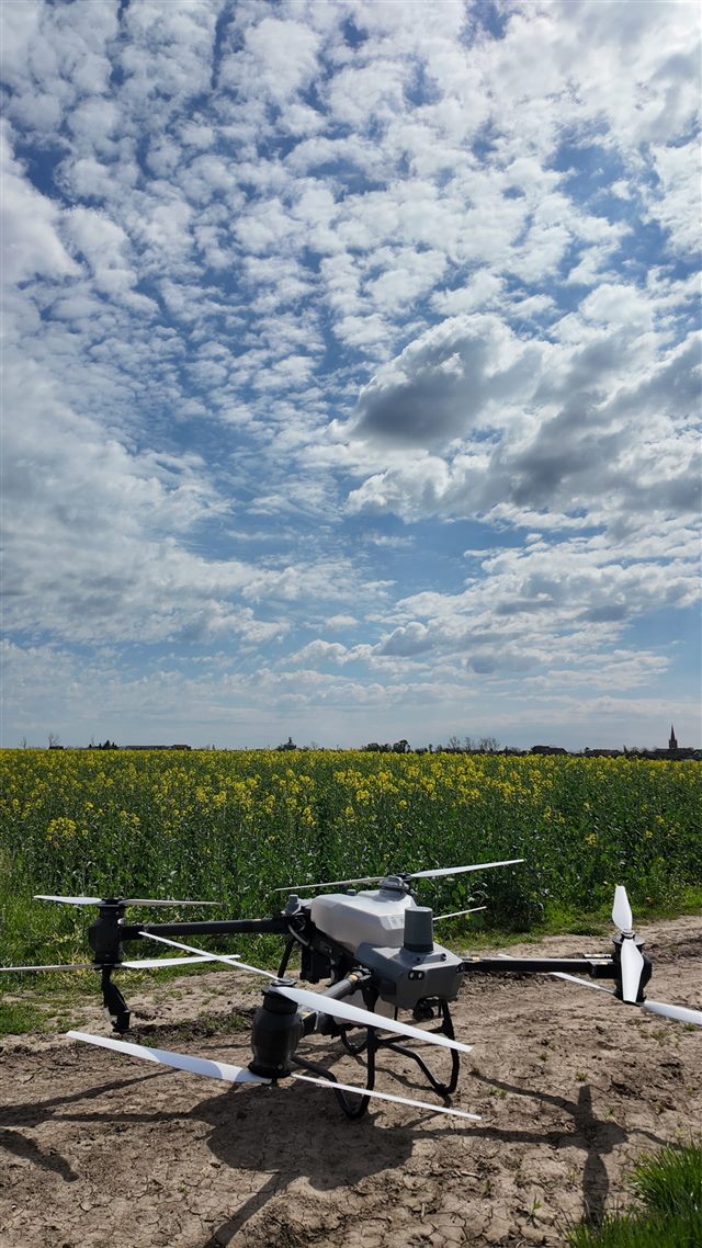Drone ready beside an oilseed rape field