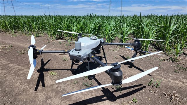 Agricultural drone beside a maize field